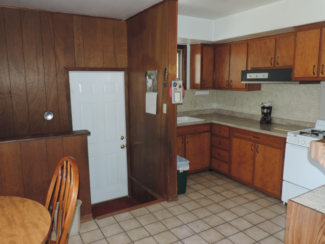 106 Thornton Street Lockport, IL 60441 - Photo 5 of 9 a kitchen with a sink a refrigerator and cabinets
