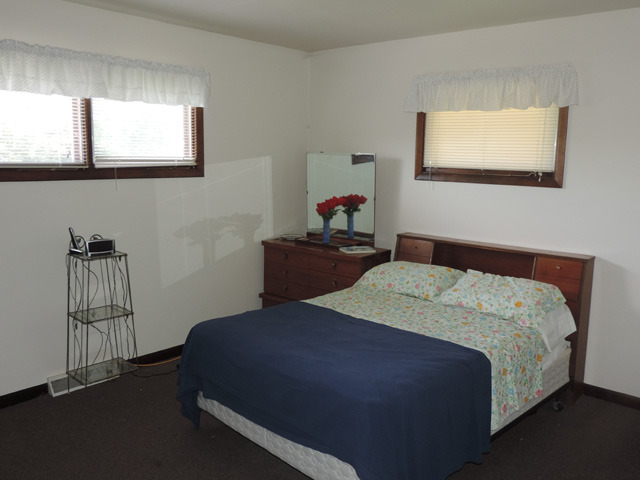 106 Thornton Street Lockport, IL 60441 - Photo 6 of 9 a bedroom with a bed and window