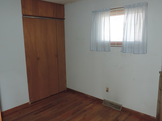 106 Thornton Street Lockport, IL 60441 - Photo 8 of 9 a view of an empty room with wooden floor and a window