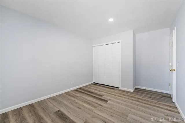 a view of room with wooden floor and white walls