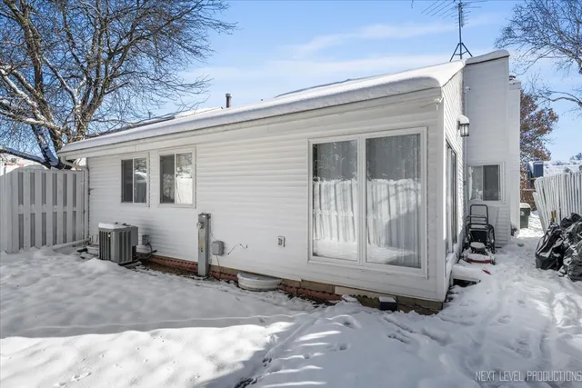a view of a house with a yard and wooden fence