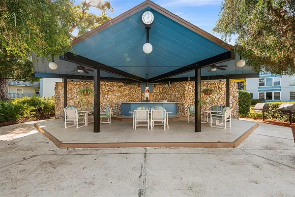 a view of a swimming pool with an outdoor seating and a mountain view