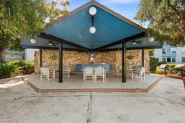 a view of a swimming pool with an outdoor seating and a mountain view