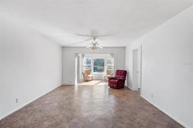 an empty room with furniture and a large window