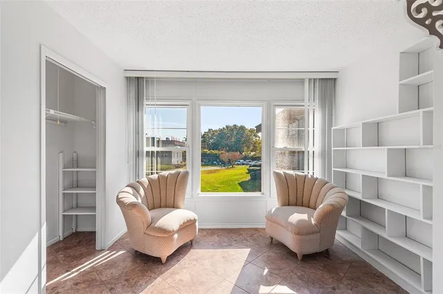 a kitchen with granite countertop a refrigerator a sink a stove and white cabinets