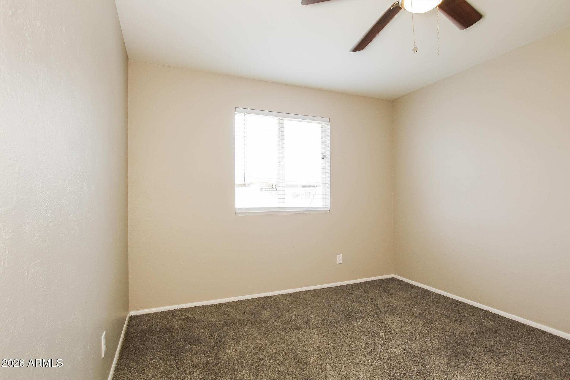 3650 West Berridge Lane Phoenix, AZ 85019 - Photo 17 of 21 an empty room with a window and a ceiling fan