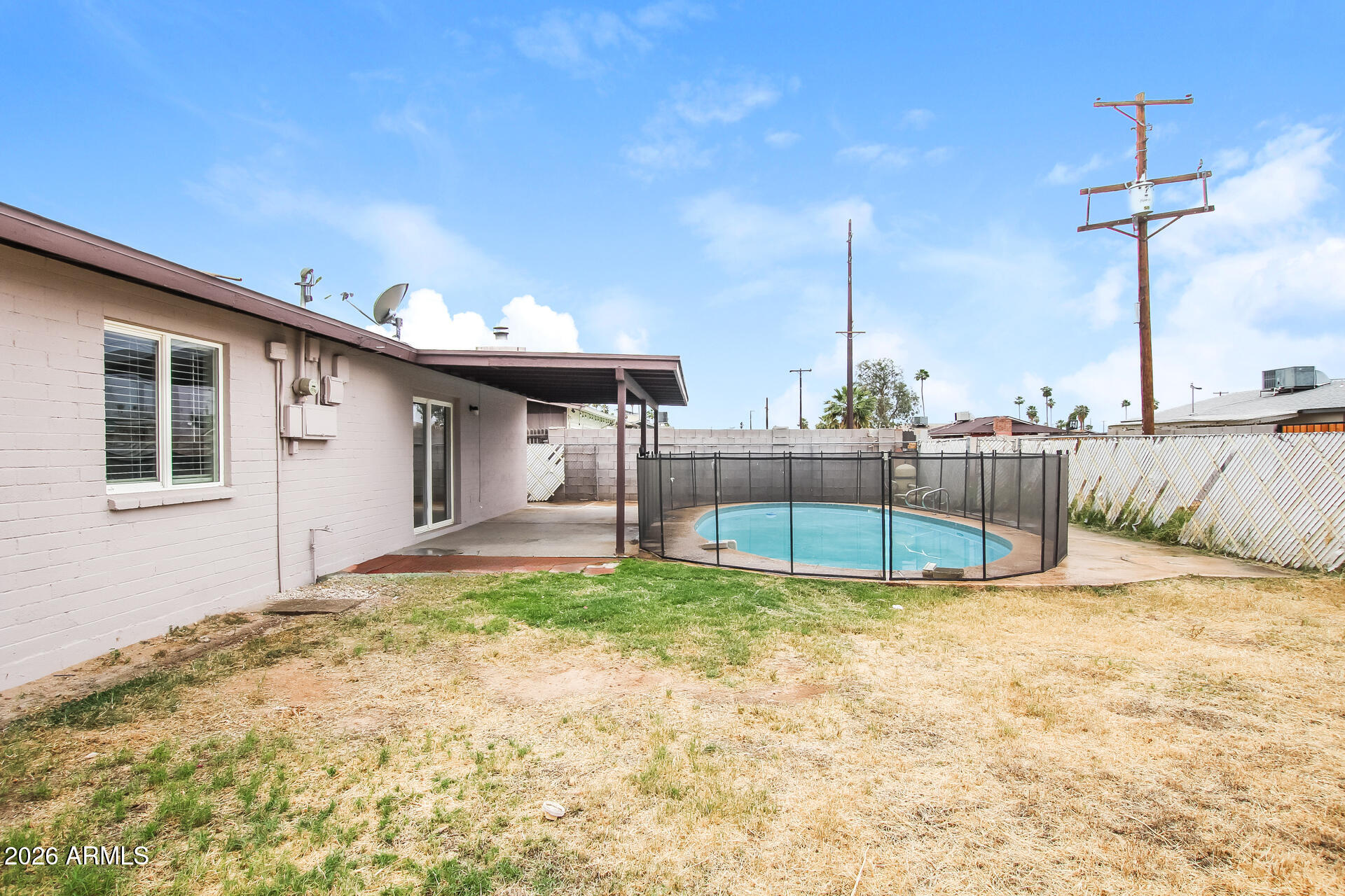 3650 West Berridge Lane Phoenix, AZ 85019 - Photo 20 of 21 a view of a house with a backyard and swimming pool