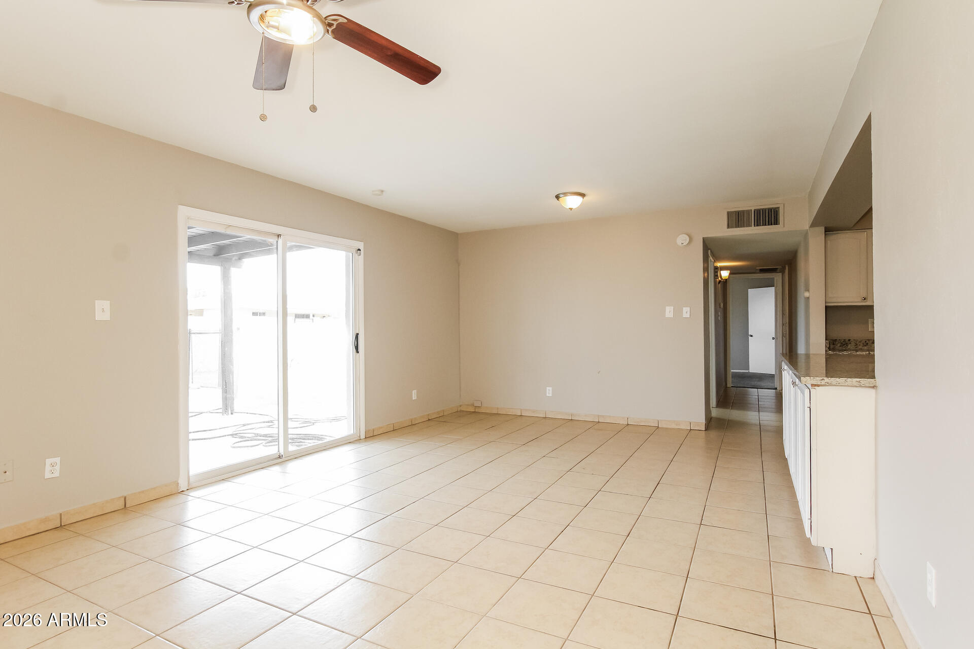 3650 West Berridge Lane Phoenix, AZ 85019 - Photo 4 of 21 a view of an empty room with a window