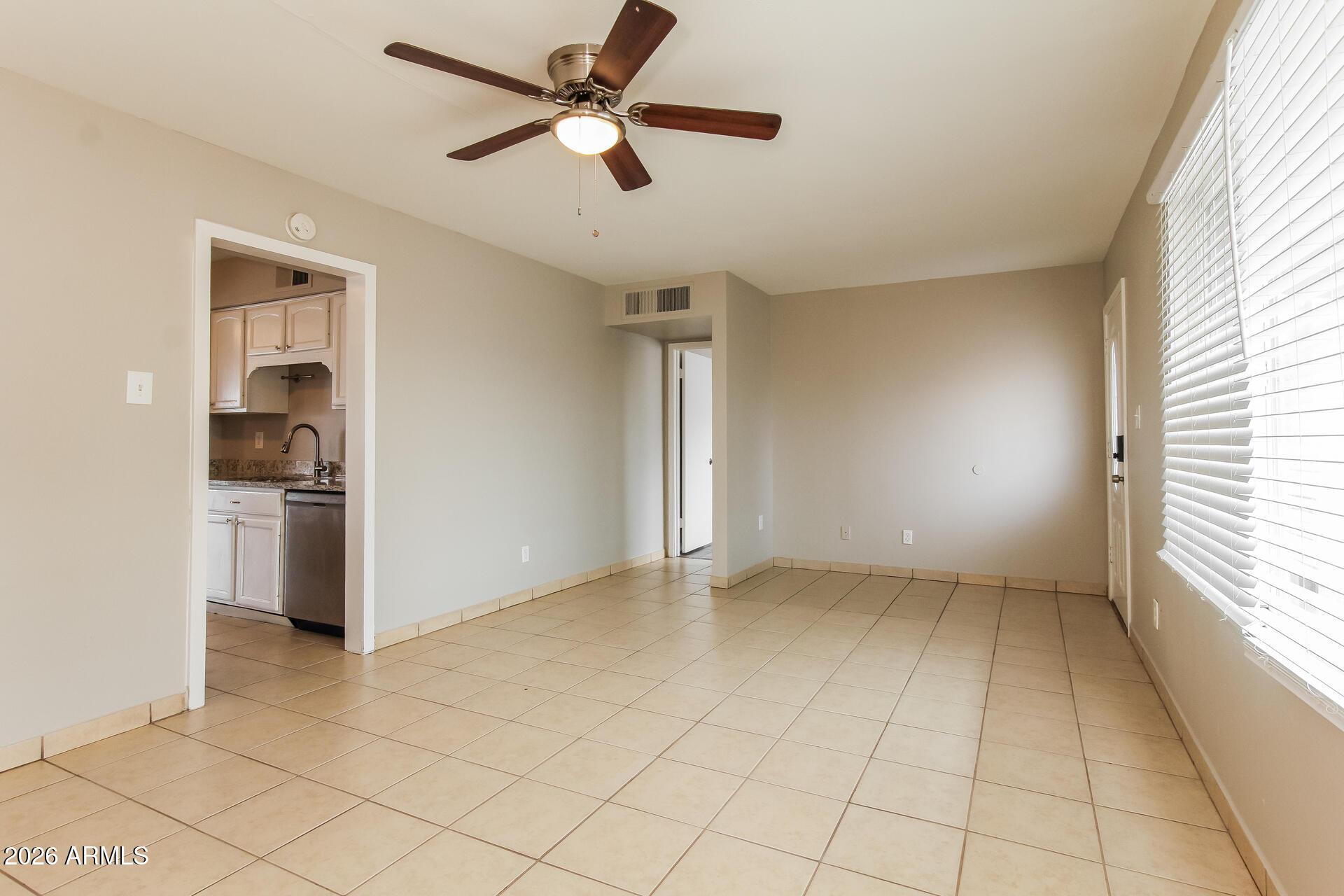 3650 West Berridge Lane Phoenix, AZ 85019 - Photo 6 of 21 an empty room with a kitchen and a window