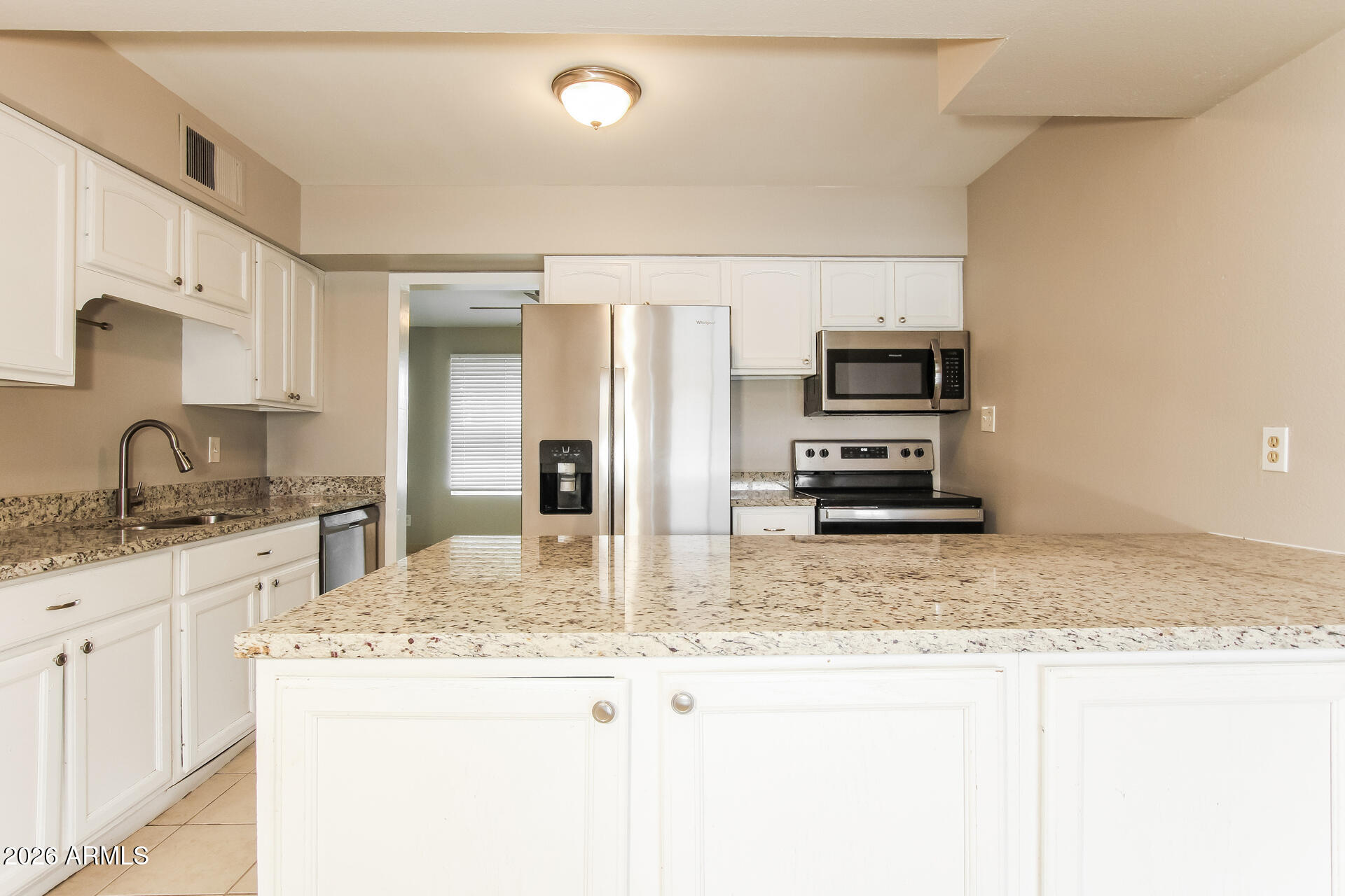 3650 West Berridge Lane Phoenix, AZ 85019 - Photo 10 of 21 a kitchen with stainless steel appliances granite countertop a sink stove and refrigerator