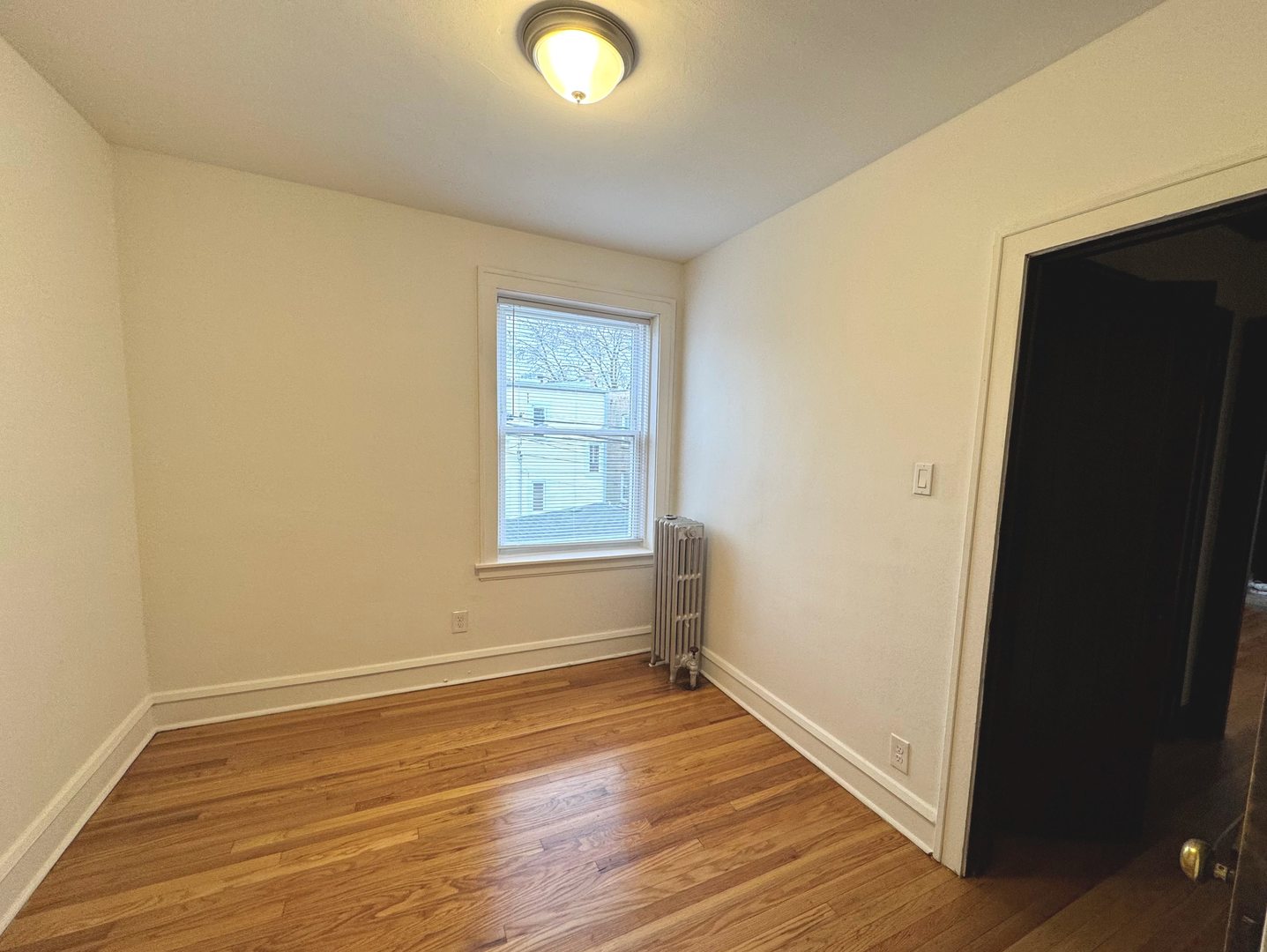 4428 North Laporte Avenue, Unit 2A Chicago, IL 60630 - Photo 13 of 22 an empty room with wooden floor and windows