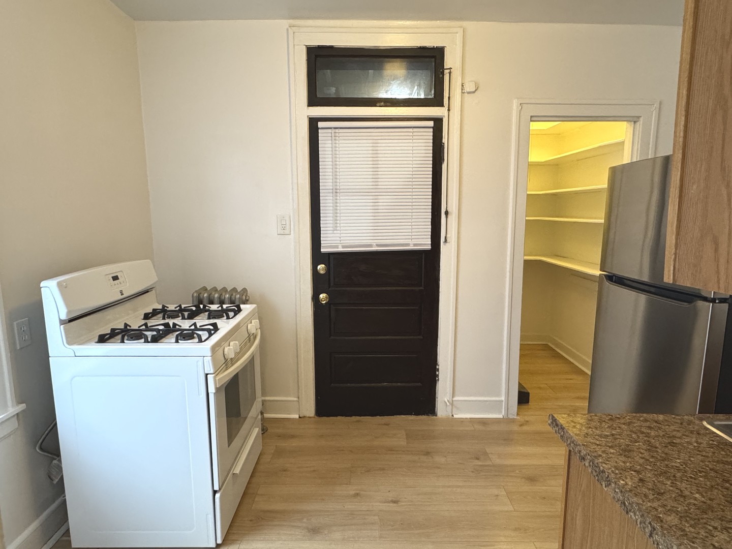 4428 North Laporte Avenue, Unit 2A Chicago, IL 60630 - Photo 16 of 22 a kitchen with a stove and a refrigerator