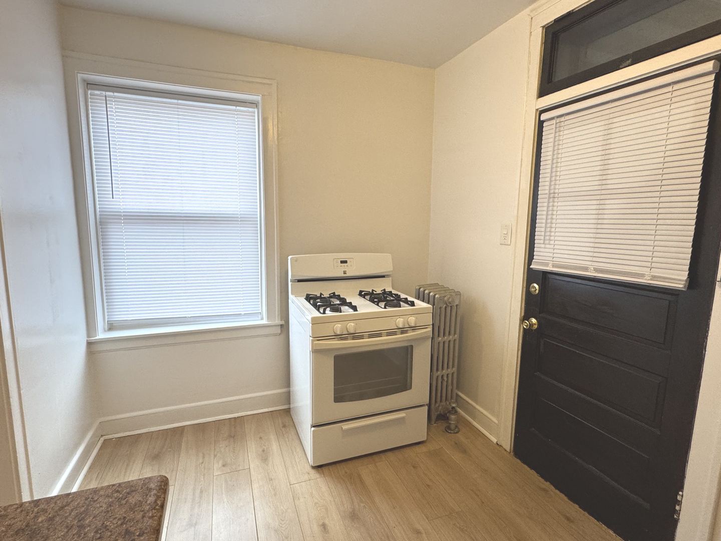 4428 North Laporte Avenue, Unit 2A Chicago, IL 60630 - Photo 20 of 22 a view of a kitchen with a stove wooden floor and a window
