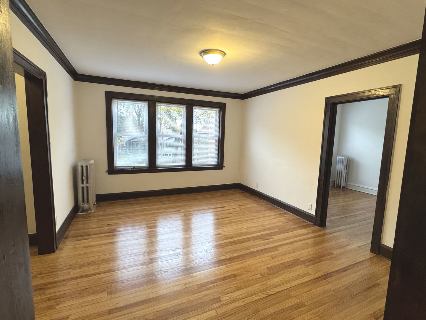 4428 North Laporte Avenue, Unit 2A Chicago, IL 60630 - Photo 5 of 22 a view of an empty room with wooden floor and a window