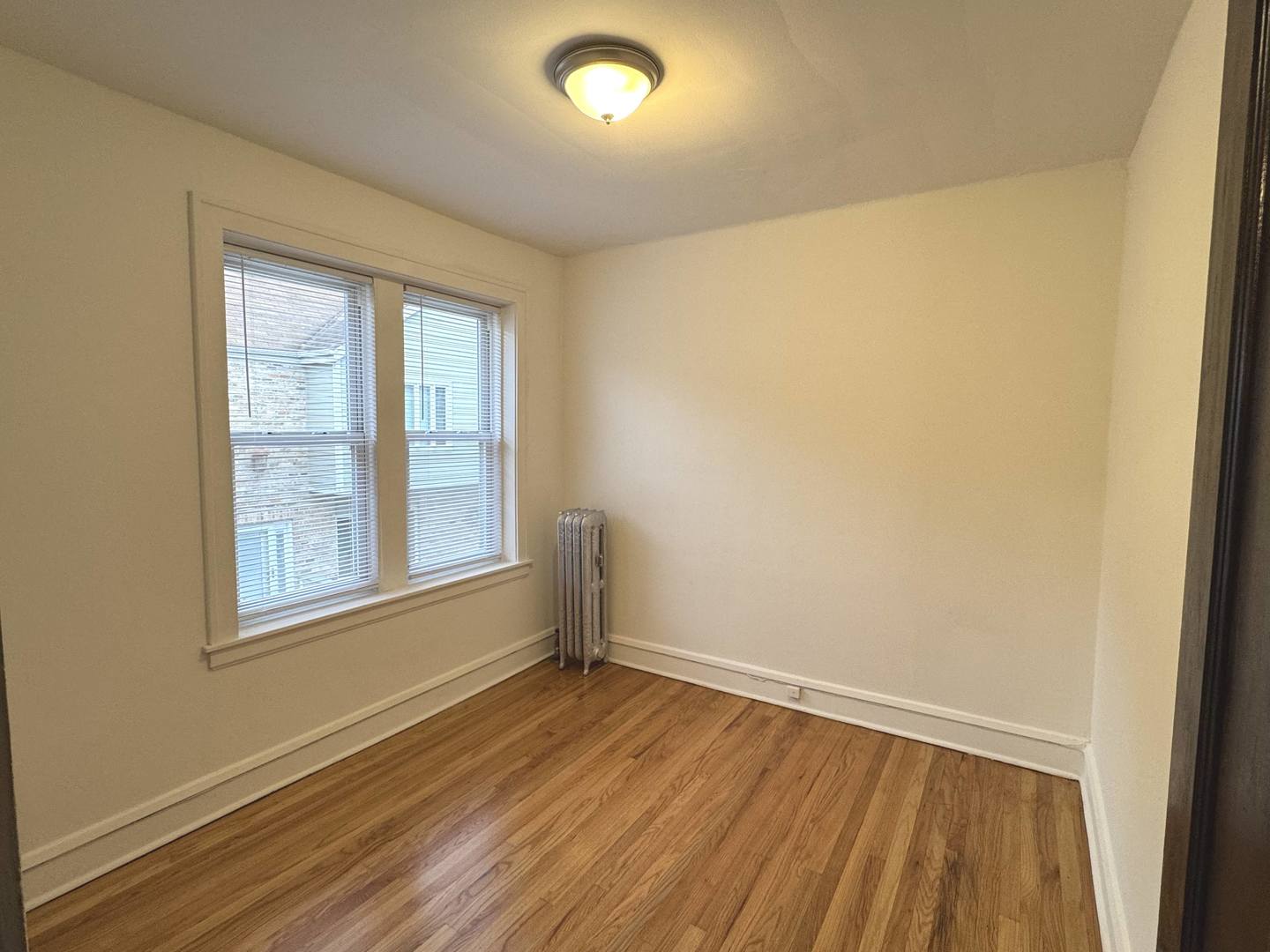 4428 North Laporte Avenue, Unit 2A Chicago, IL 60630 - Photo 7 of 22 an empty room with wooden floor and windows