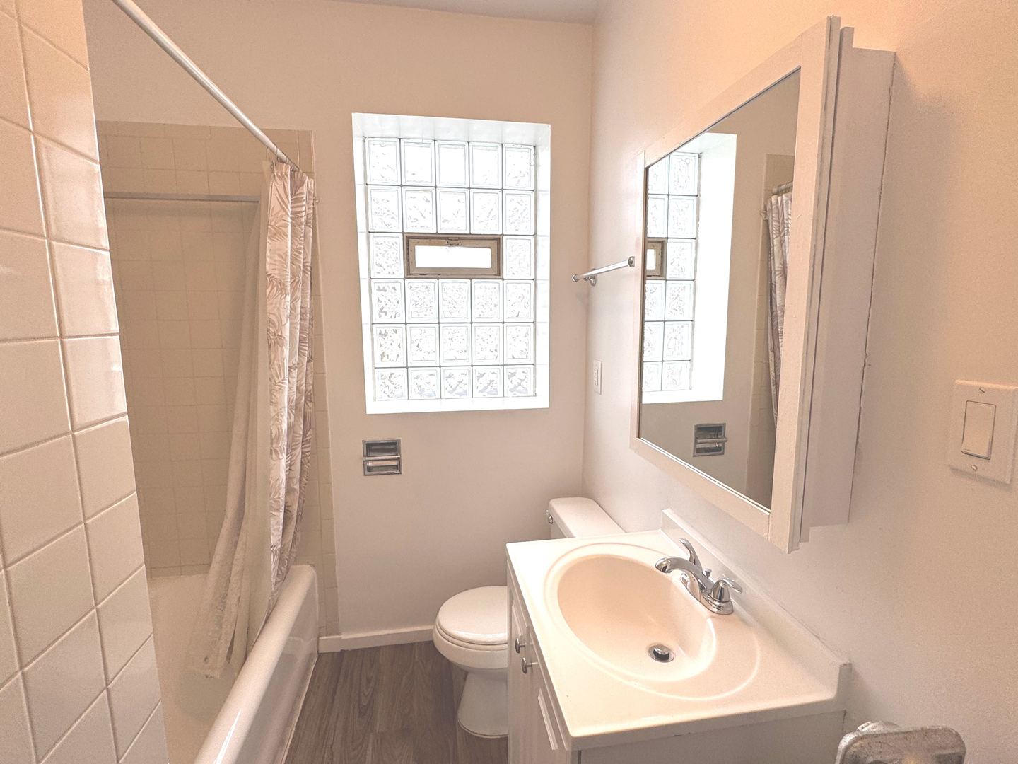 4428 North Laporte Avenue, Unit 2A Chicago, IL 60630 - Photo 9 of 22 a bathroom with a sink toilet a mirror and shower