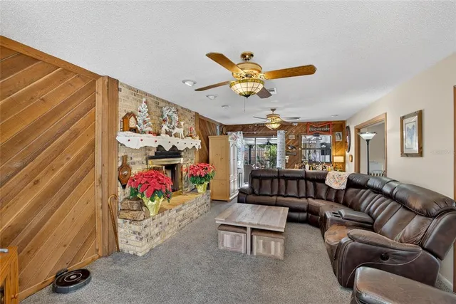 a living room with furniture and a ceiling fan