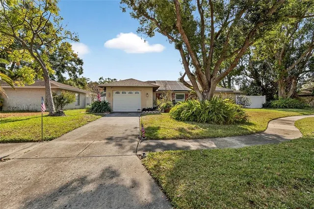 a view of a house with backyard and tree s