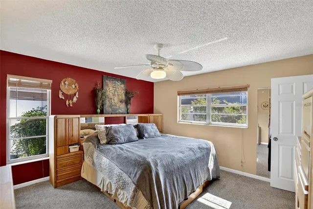 a bedroom with a large bed and a window