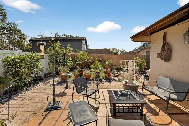 a view of a patio with chairs and potted plants