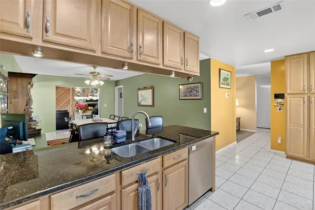 a kitchen with stainless steel appliances granite countertop a sink and cabinets