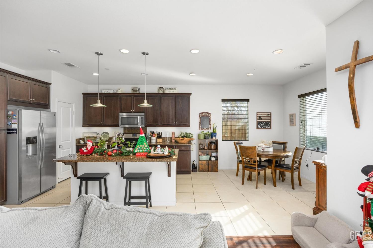 Undisclosed Address Bakersfield, CA 93313 - Photo 11 of 27 a view of a dining area with furniture and chandelier