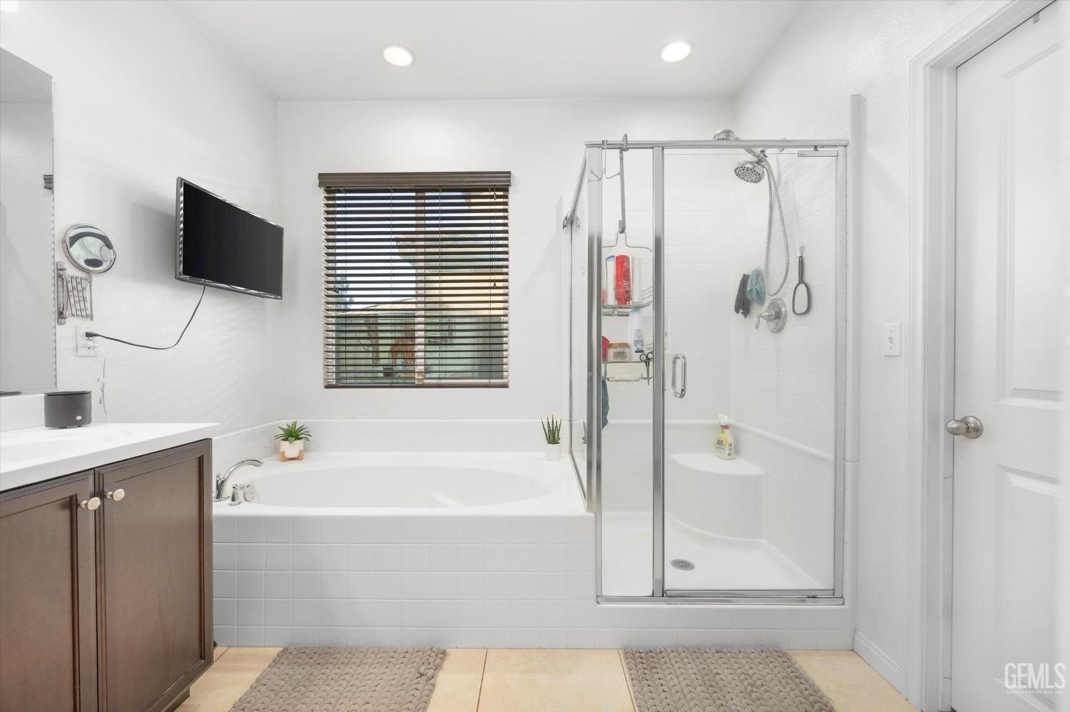 Undisclosed Address Bakersfield, CA 93313 - Photo 17 of 27 a bathroom with a tub a sink and a mirror