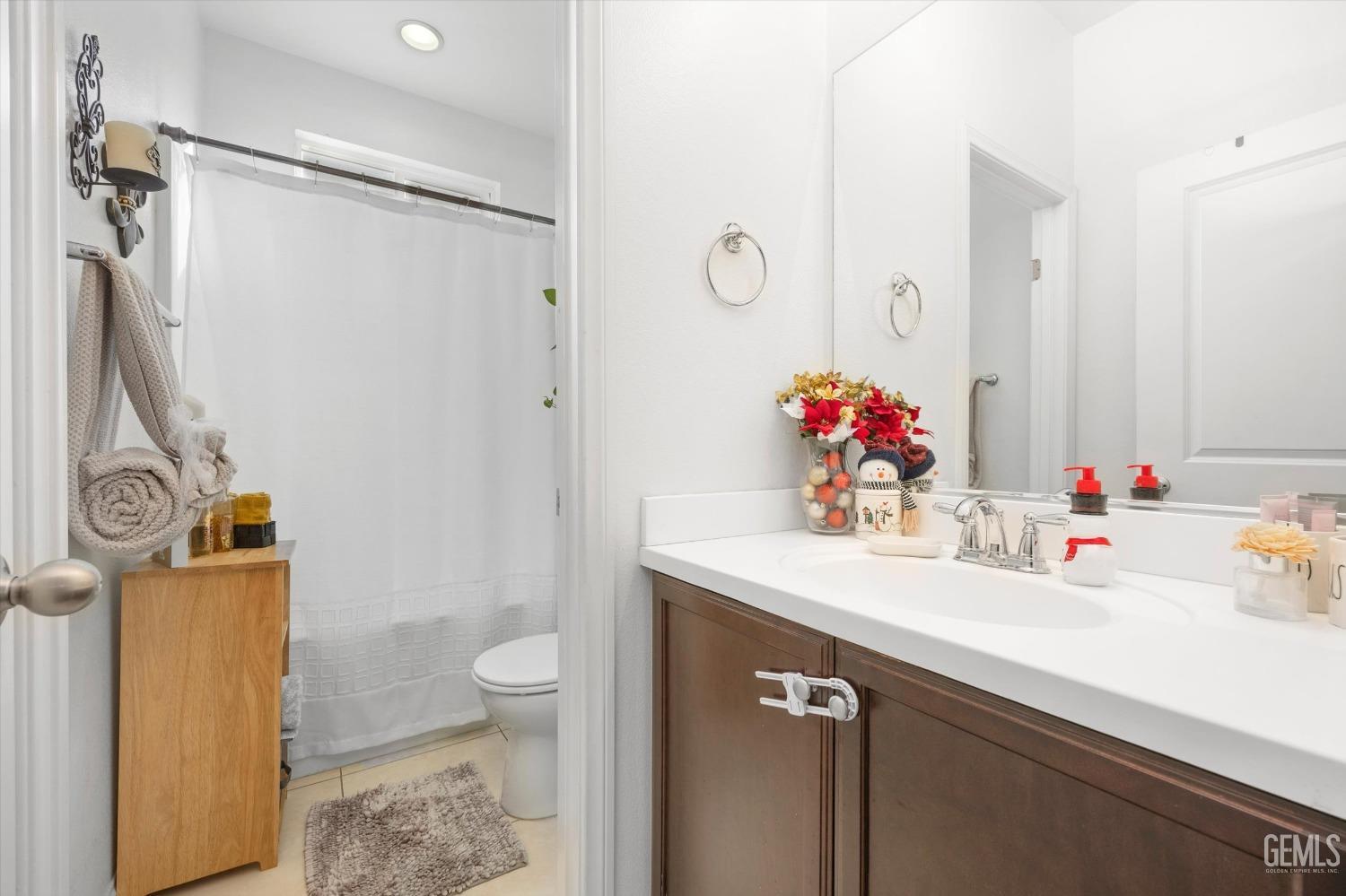 Undisclosed Address Bakersfield, CA 93313 - Photo 20 of 27 a bathroom with a sink vanity mirror and toilet