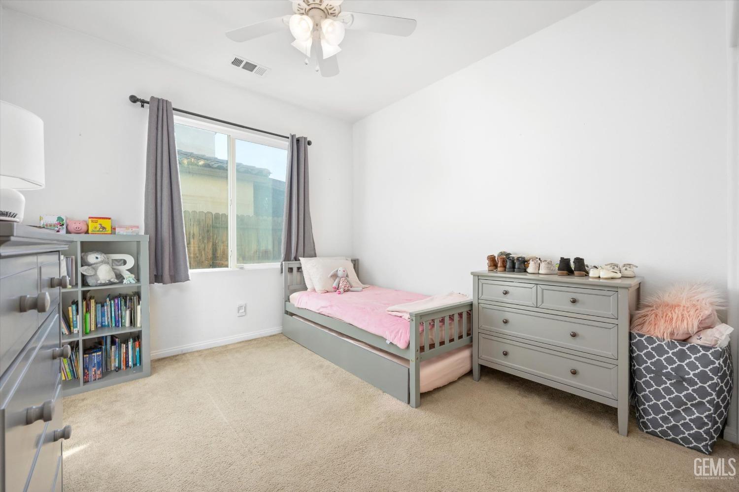 Undisclosed Address Bakersfield, CA 93313 - Photo 21 of 27 a bedroom with a bed and a book shelf