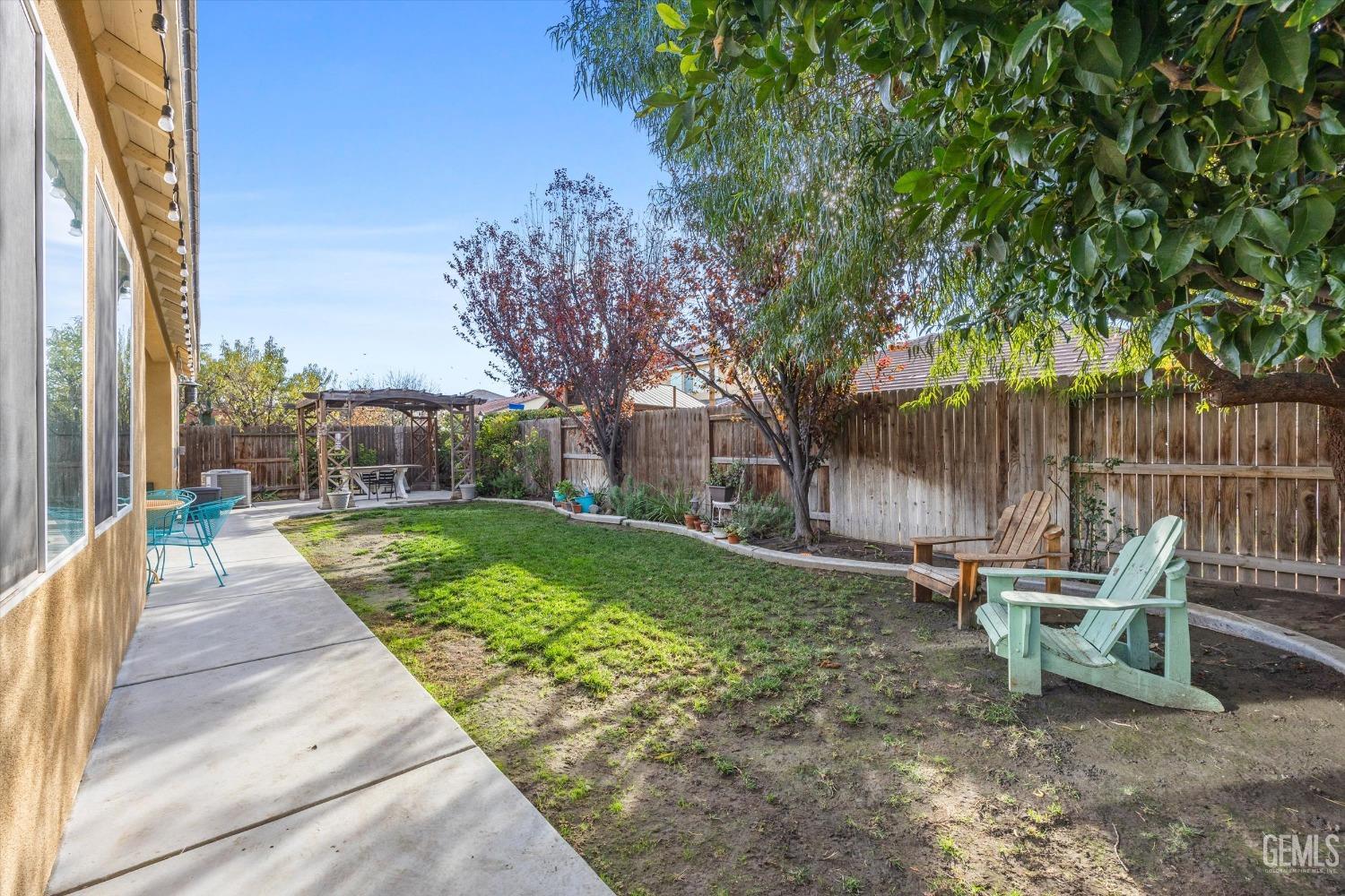 Undisclosed Address Bakersfield, CA 93313 - Photo 27 of 27 a view of a chair and table in backyard of the house