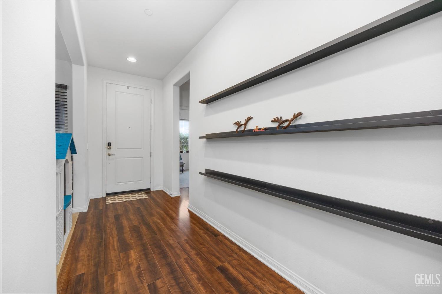 Undisclosed Address Bakersfield, CA 93313 - Photo 6 of 27 a view of a hallway with wooden floor and closet