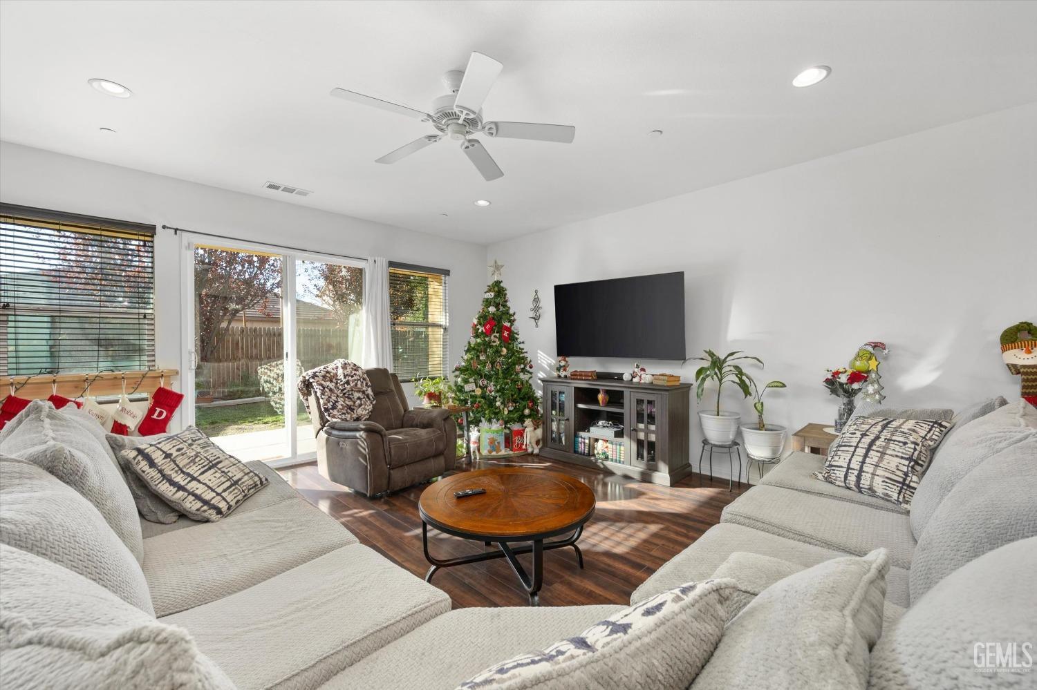 Undisclosed Address Bakersfield, CA 93313 - Photo 8 of 27 a living room with furniture a flat screen tv and a large window