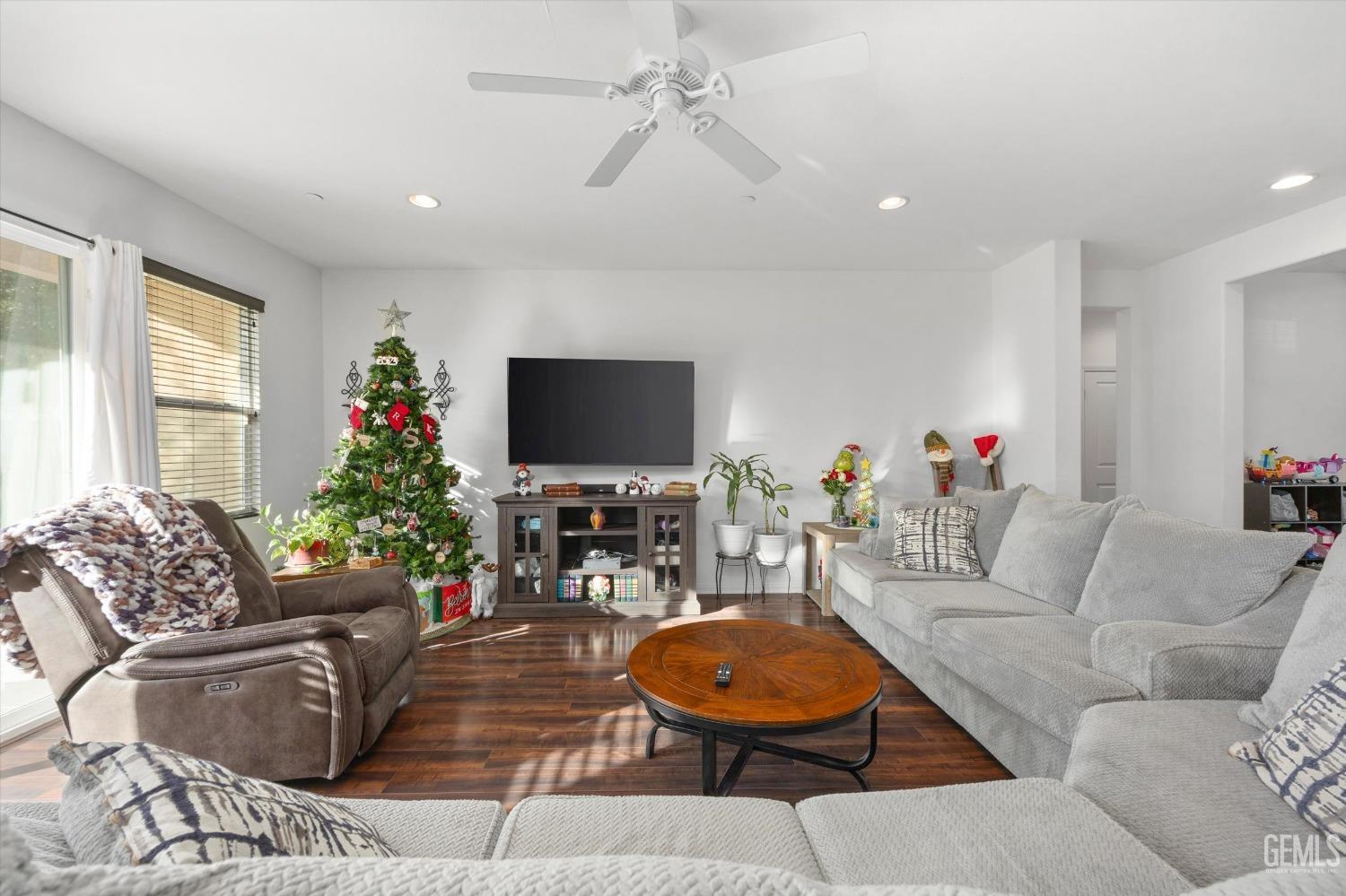 Undisclosed Address Bakersfield, CA 93313 - Photo 9 of 27 a living room with furniture a flat screen tv and a large window