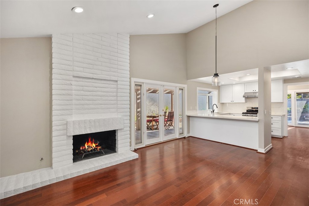 10 Rippling Streme Irvine, CA 92603 - Photo 14 of 31 a large kitchen with a wooden floor and a fireplace