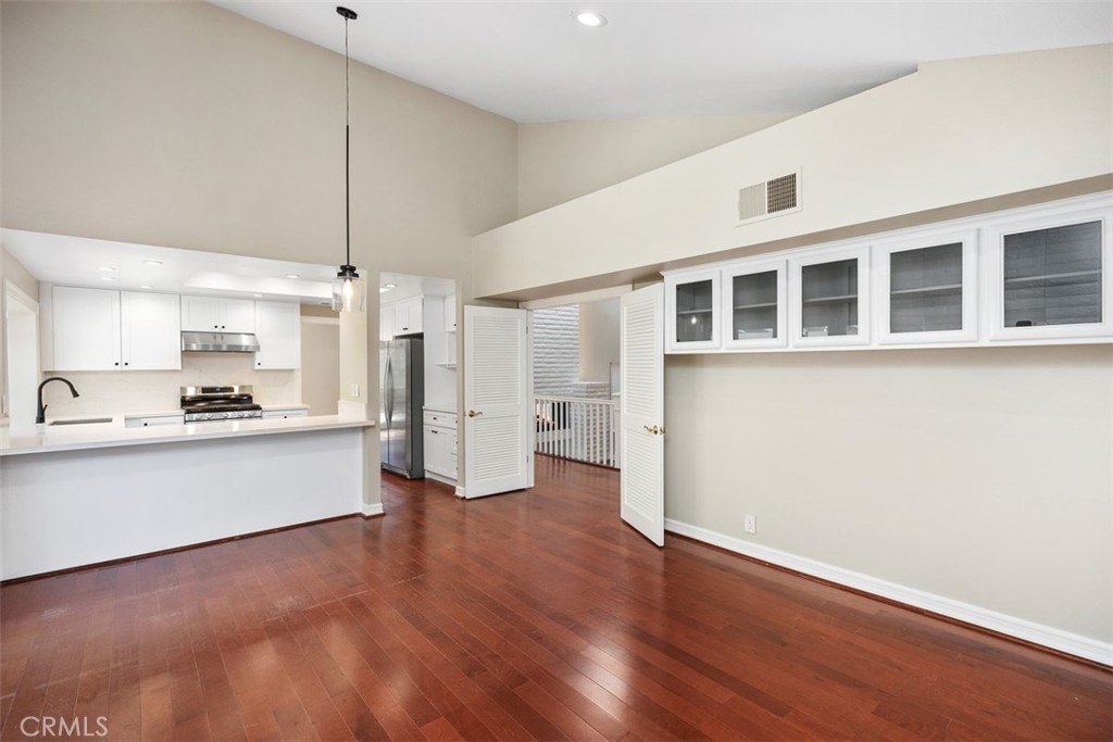 10 Rippling Streme Irvine, CA 92603 - Photo 16 of 31 a large white kitchen with a refrigerator a sink dishwasher and a stove top oven