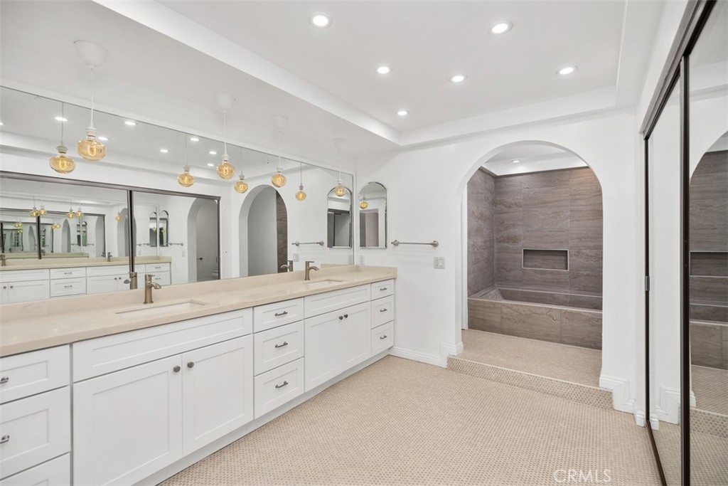 10 Rippling Streme Irvine, CA 92603 - Photo 23 of 31 a spacious bathroom with a shower a sink and mirror