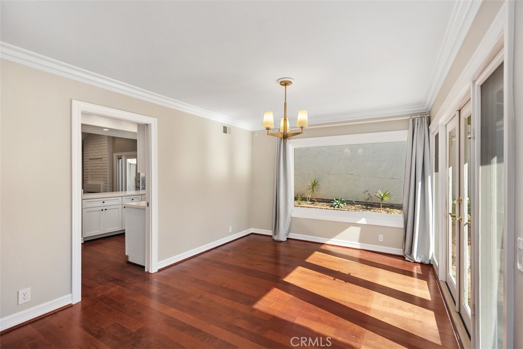 10 Rippling Streme Irvine, CA 92603 - Photo 7 of 31 a view of a hallway with wooden floor and a bathroom