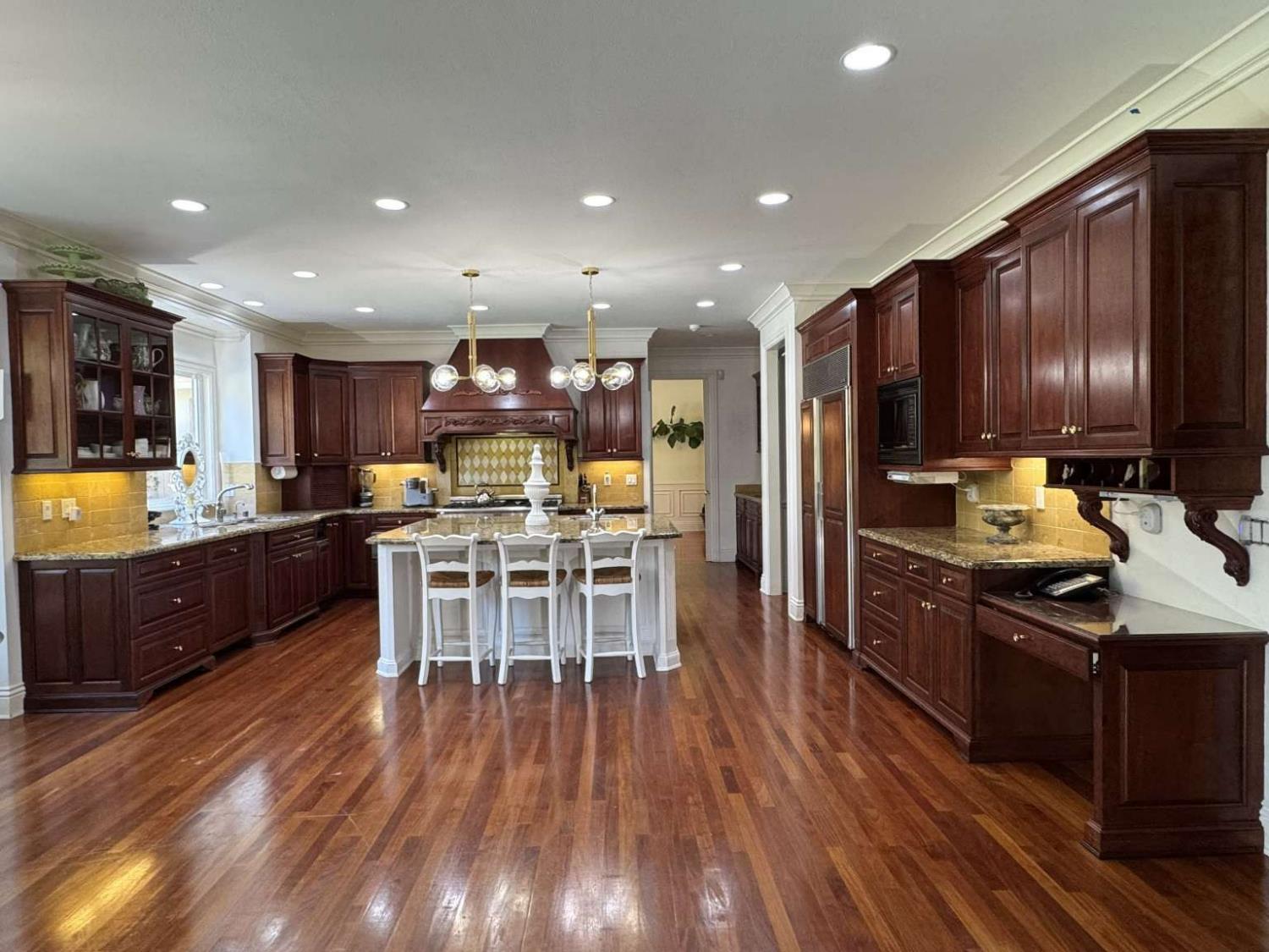 5403 Blackhawk Drive Danville, CA 94506 - Photo 13 of 47 a kitchen with stainless steel appliances kitchen island granite countertop wooden floors refrigerator and cabinets
