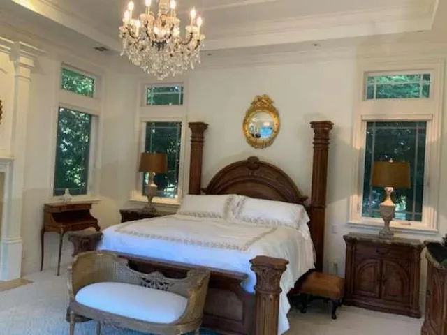 a spacious bathroom with a granite countertop double vanity and a large mirror