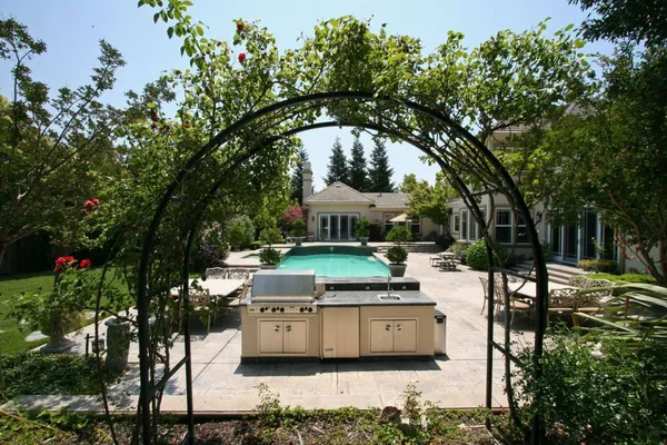 a view of a patio with table and chairs and potted plants