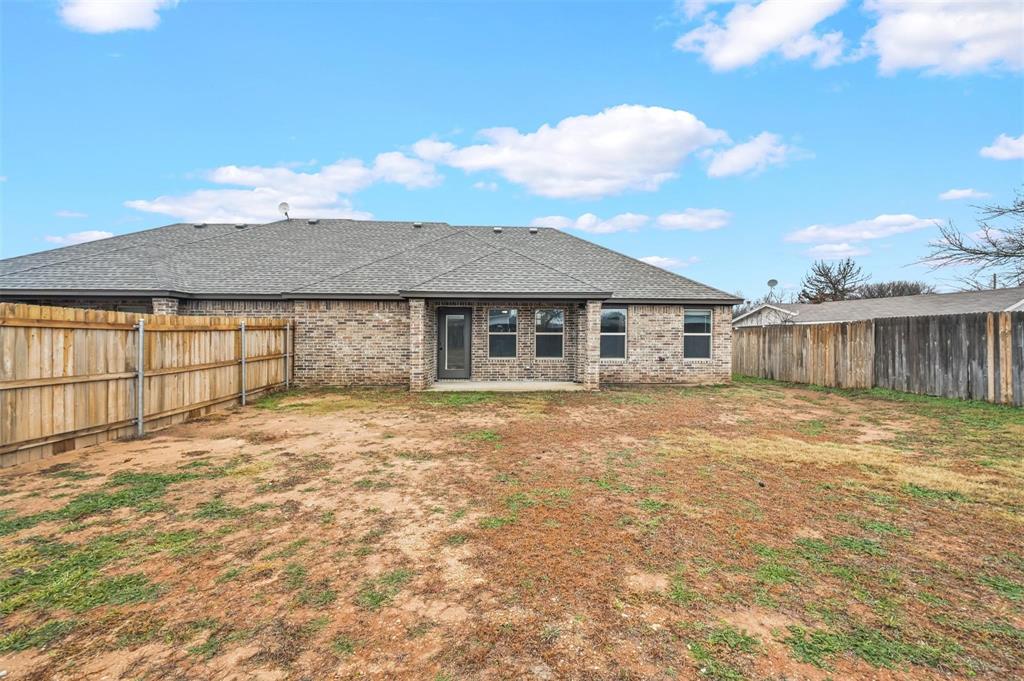 228 St Charles Drive, Unit B Springtown, TX 76082 - Photo 17 of 20 a view of a house with a backyard and a garden