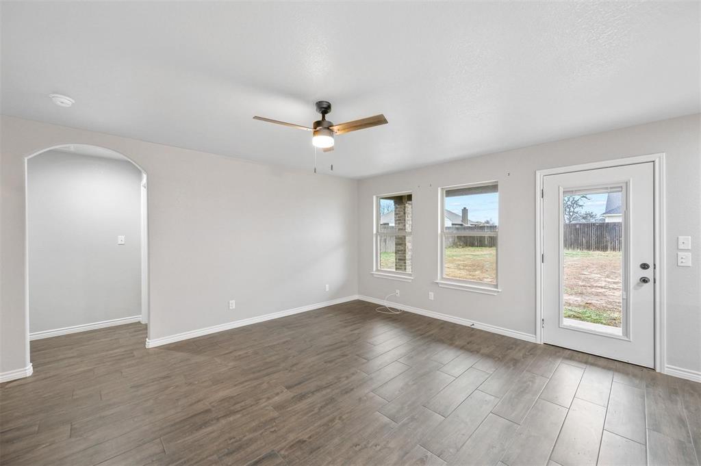 228 St Charles Drive, Unit B Springtown, TX 76082 - Photo 6 of 20 a view of an empty room with a window and wooden floor