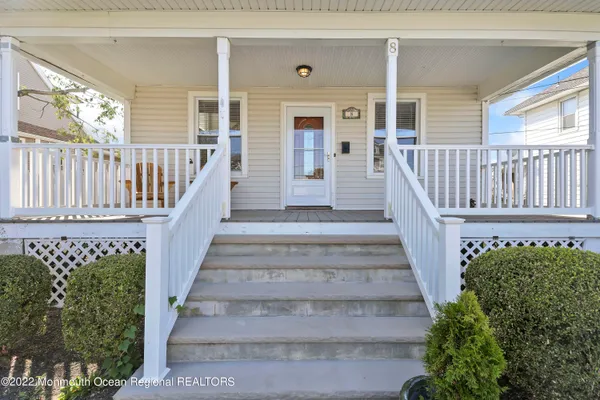 a view of entryway with wooden floor and a front door