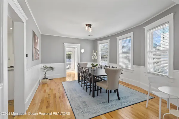 a view of a a dining room with furniture window and wooden floor