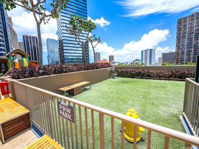 a view of a balcony with two plants and a swing chair
