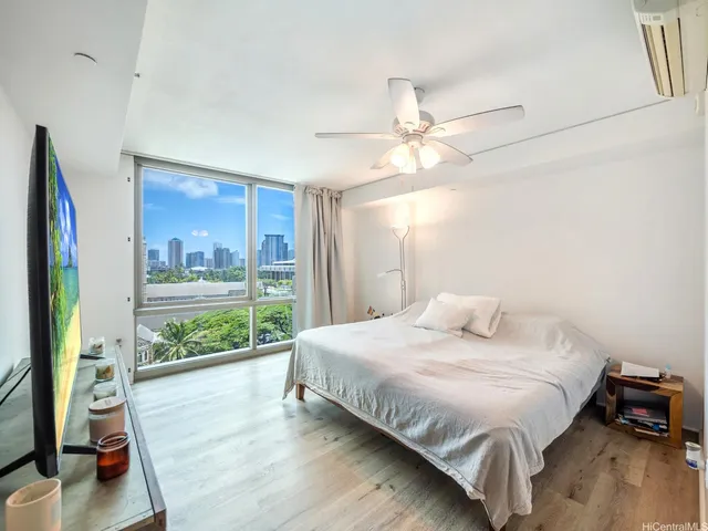 a bedroom with a bed and a large window with outer view