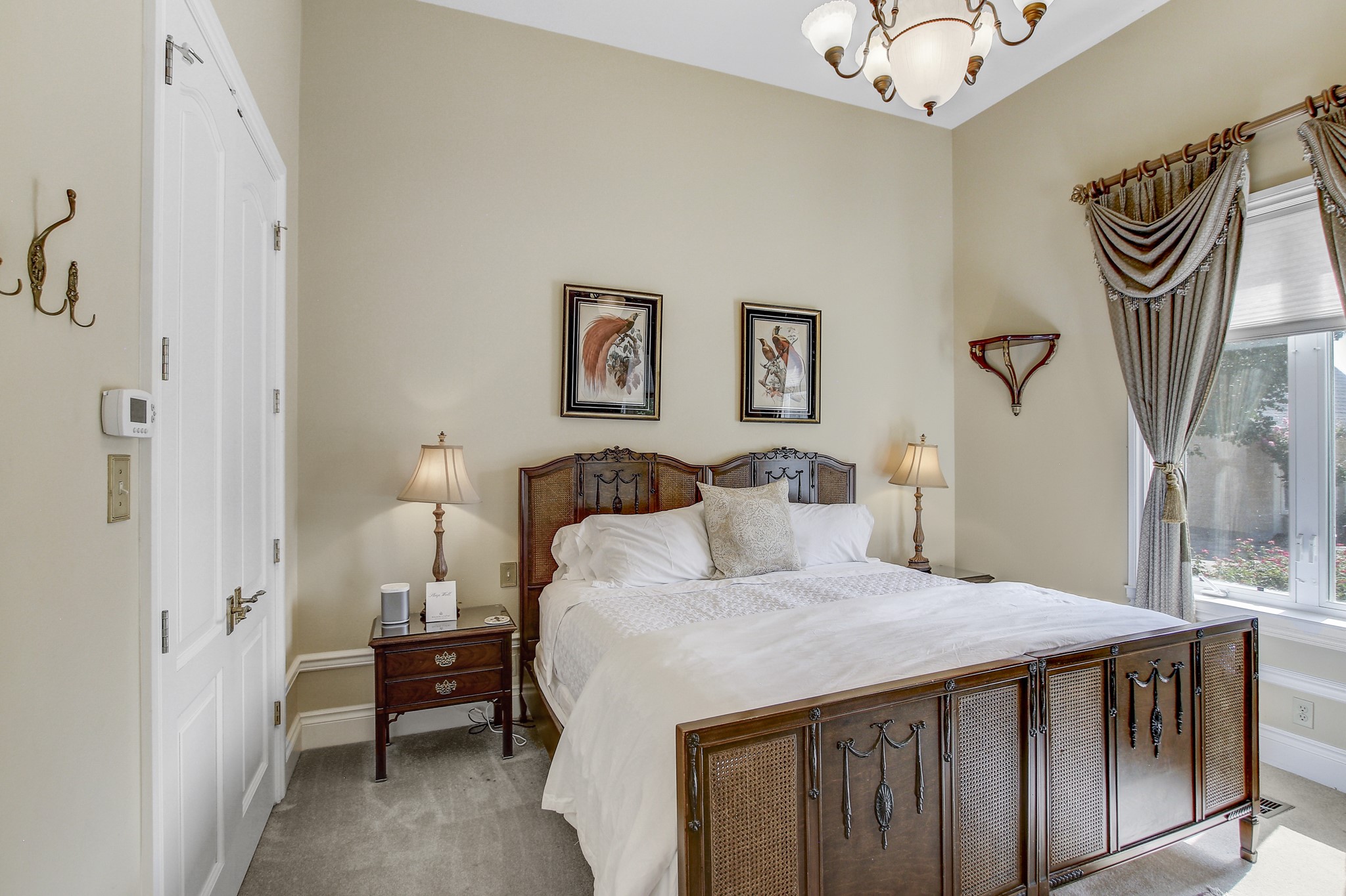 13628 Gregg Manor Road Manor, TX 78653 - Photo 23 of 33 a bedroom with a bed and a chandelier