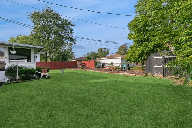 a view of a house with backyard sitting area and garden
