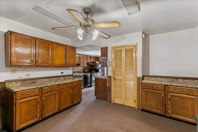 a kitchen with cabinets stainless steel appliances and a window