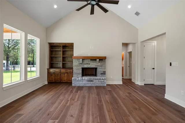 a view of a livingroom with a fireplace and window